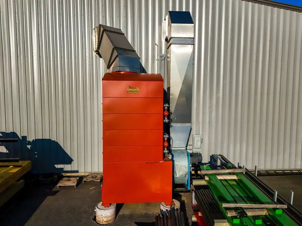 Red dust collector with blower mounted outside a steel building at Diamond Ridge | CSI Collector Systems - Dust & Fume Collection Systems